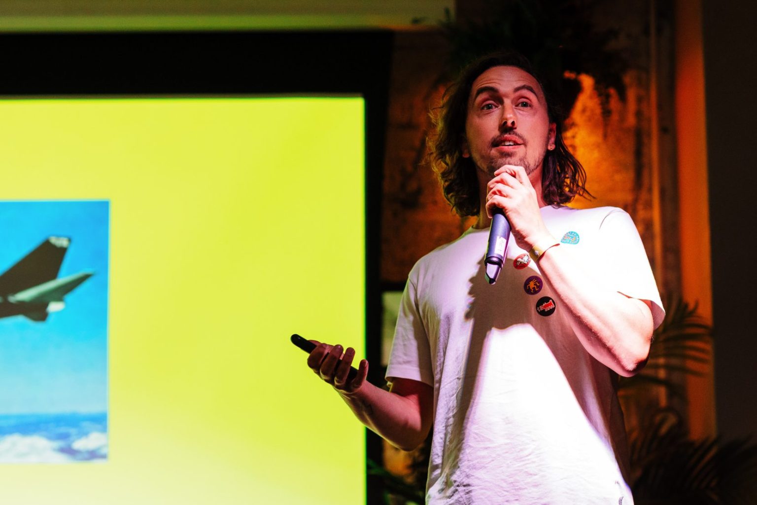 Speaking on stage at a Kindred event